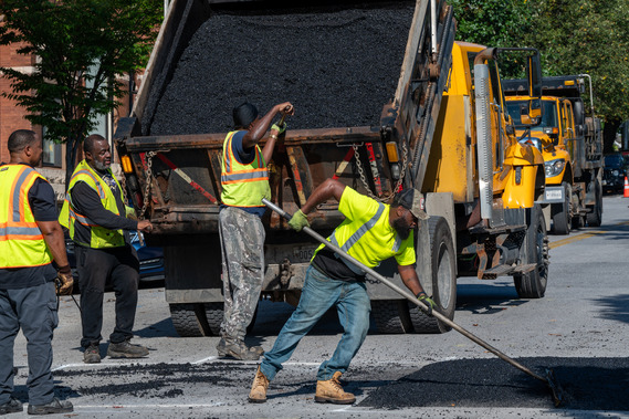 Workers asphalting a road