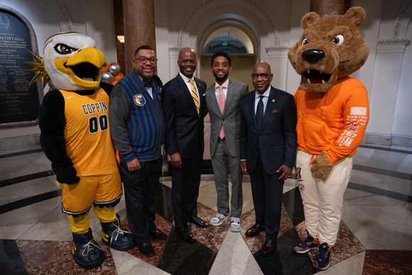 Mayor Brandon M. Scott with people and Morgan State and Coppin mascot characters