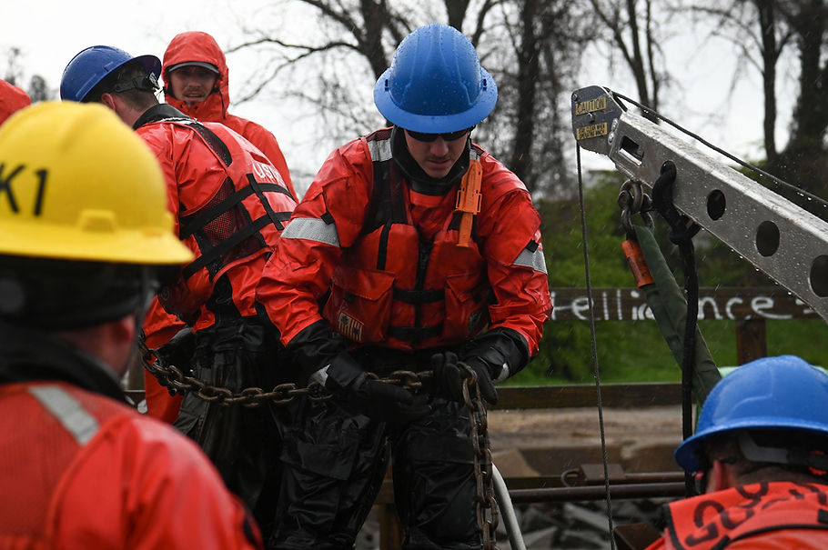 U.S. Coast Guard Aids to Navigation Team (ANT) Baltimore works together to load buoy channel markers on a small-boat in the Patapsco River in Baltimore, Maryland, April 2, 2024