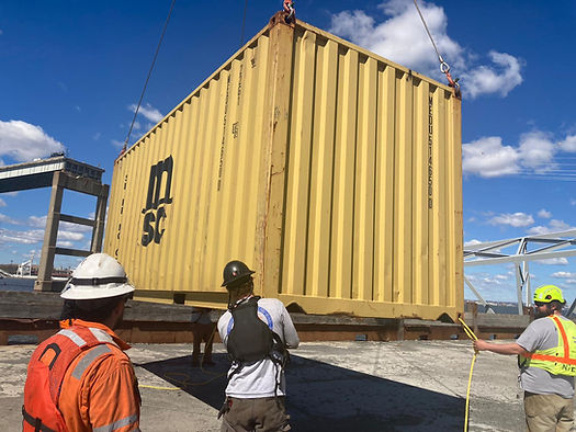 Response crews began removing shipping containers using a floating crane barge at the site of the Francis Scott Key Bridge on April 7, 2024