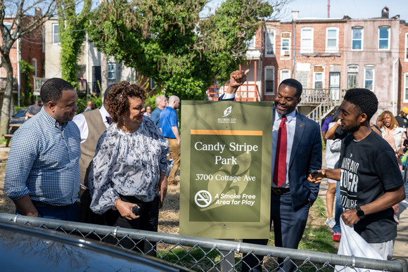 Mayor Brandon M. Scott next to sign for newly renamed Candy Stripe Park