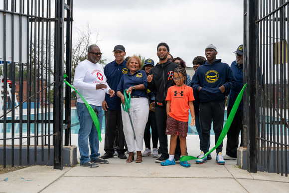 Mayor Scott cuts ribbon on Ambrose Swimming Pool alongside community members and young people.