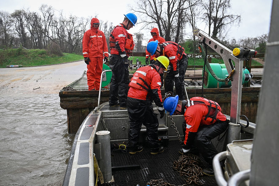 U.S. Coast Guard Aids to Navigation Team (ANT) Baltimore  Navigation Team pulls chains connected to buoy channel markers while onloading buoys at a boat ramp in Baltimore, Maryland, April 2, 2024