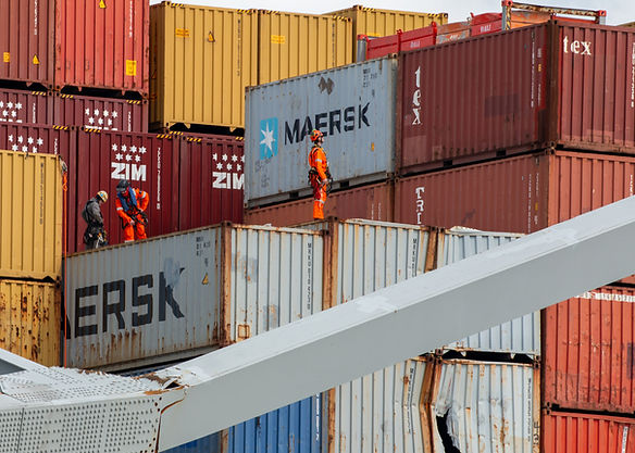 Salvage operators assess damaged containers aboard the M/V Dali on April 6, 2024