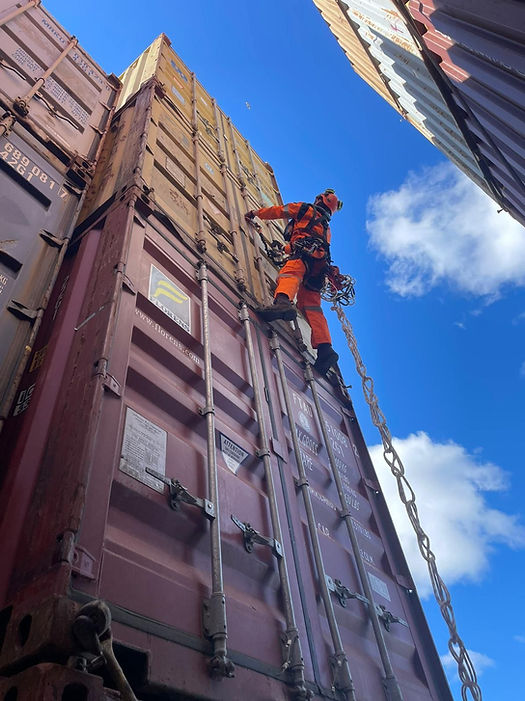 A specialized salvage climber scales a container to survey damage to containers onboard the M/V DALI in Baltimore on April 6, 2024