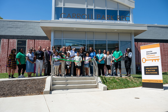 City leaders and community members cut the ribbon on the newly-renovated Carroll Park Recreation Center