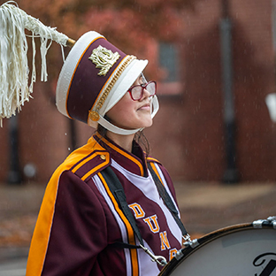 Marching band member with drum